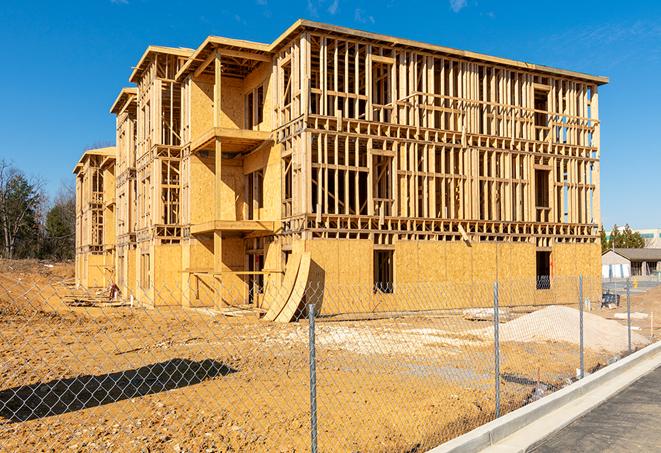 workers protected by temporary barrier fence during building maintenance in Onalaska, TX